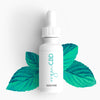 CBD Oil peppermint flavored with peppermint leaves background